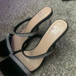 Black heels,with sparkly straps, square at the foot,and clear heel